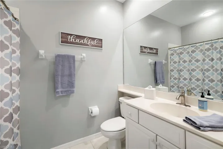 Bathroom with tile patterned floors, vanity, and toilet