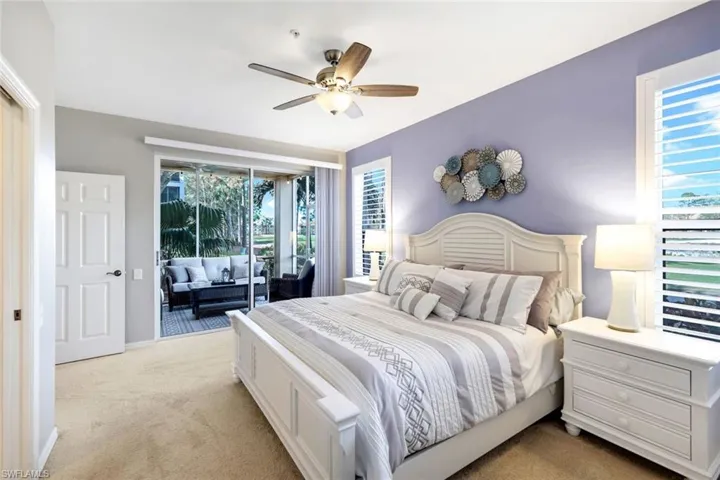 Carpeted bedroom with access to outside and ceiling fan
