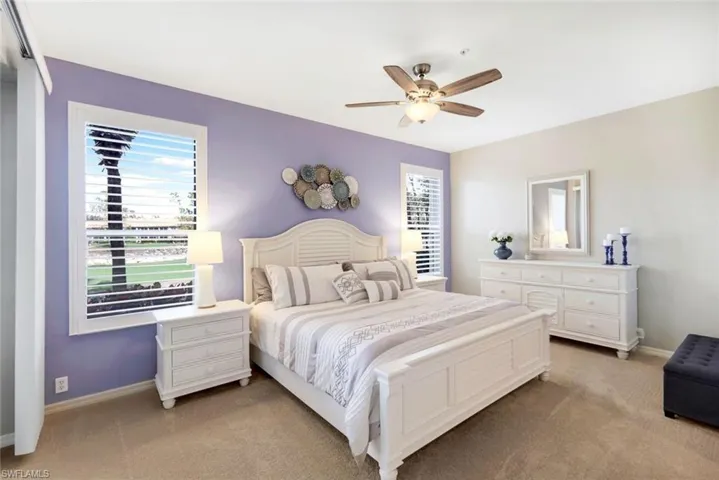 Carpeted bedroom with ceiling fan