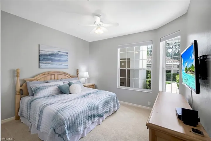 Bedroom featuring light colored carpet and ceiling fan