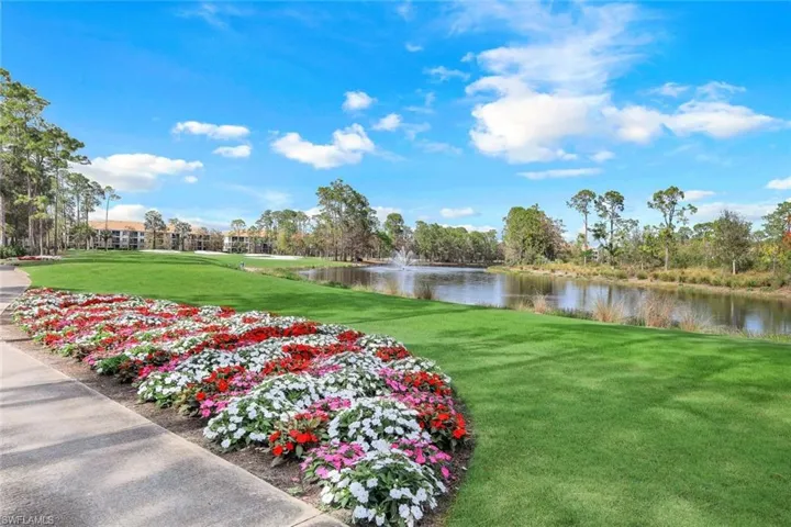 View of community featuring a yard and a water view