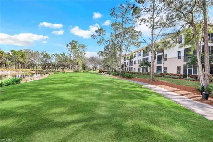 View of property's community with a yard and a water view