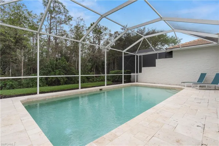 View of swimming pool with a lanai and a patio area