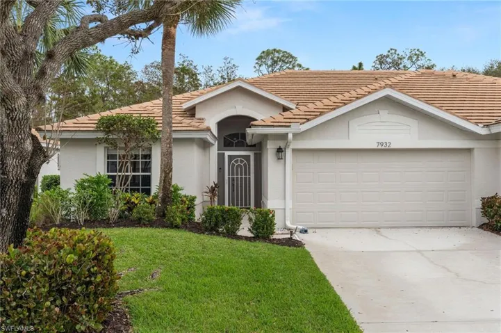 Ranch-style house with a garage and a front yard