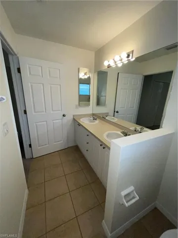 Bathroom featuring a sink and light tile patterned flooring