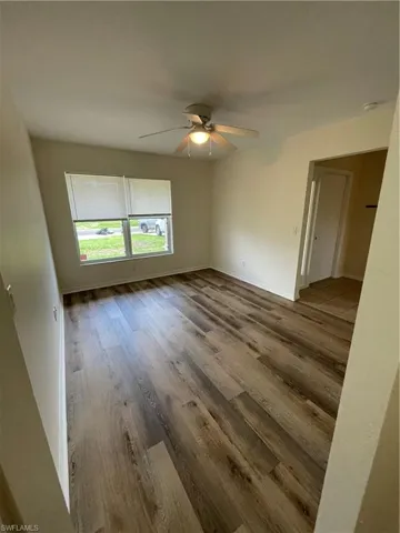 Unfurnished room with wood finished floors and ceiling fan