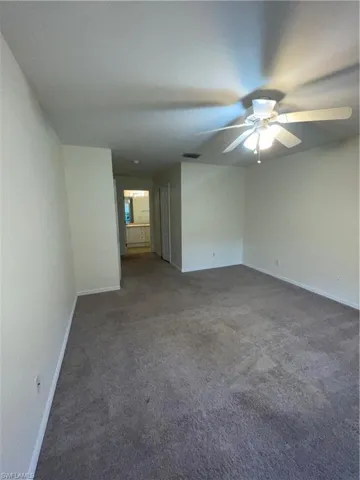 Empty room featuring carpet and a ceiling fan