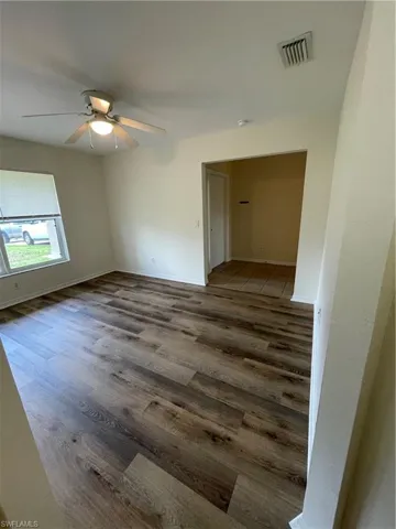 Unfurnished room with wood finished floors and ceiling fan