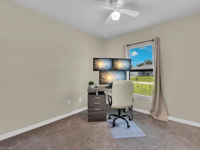 Living room featuring light wood-type flooring, vaulted ceiling, and a ceiling fan