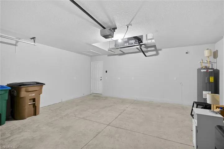 Garage with water heater and a garage door opener