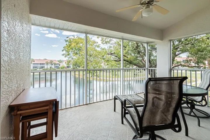 Screened balcony with a water view and ceiling fan