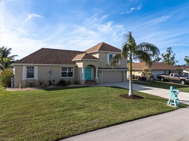 View of front of property with a front lawn and a garage