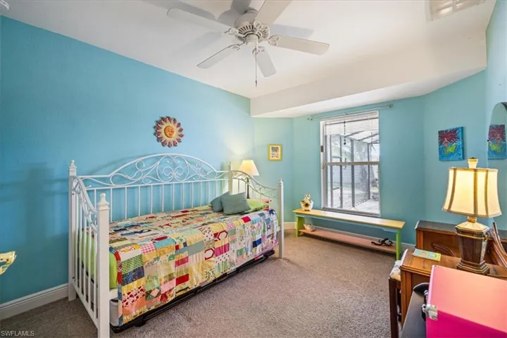 Bedroom with ceiling fan and carpet floors
