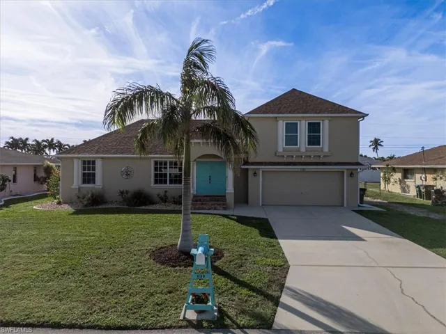 View of front of home featuring a garage and a front lawn