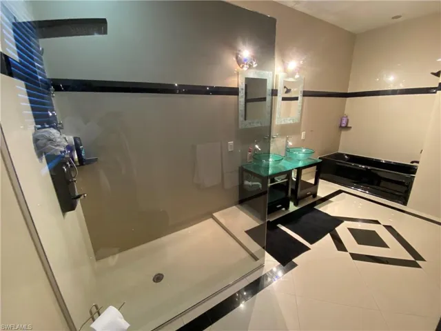 Bathroom with tile patterned flooring and sink