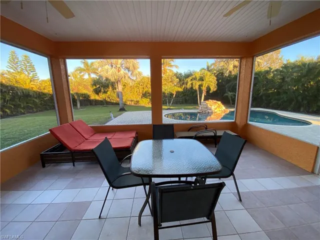 Sunroom / solarium with ceiling fan and wooden ceiling