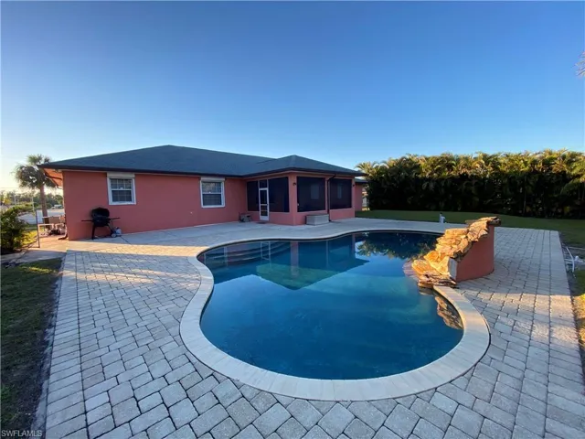 View of pool featuring a patio area and a sunroom