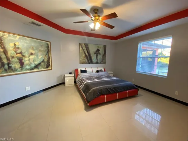 Bedroom with tile patterned flooring and ceiling fan