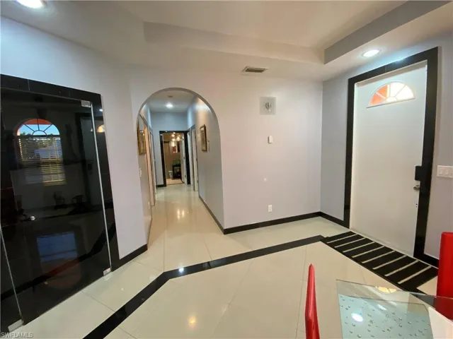 Tiled foyer entrance with a raised ceiling