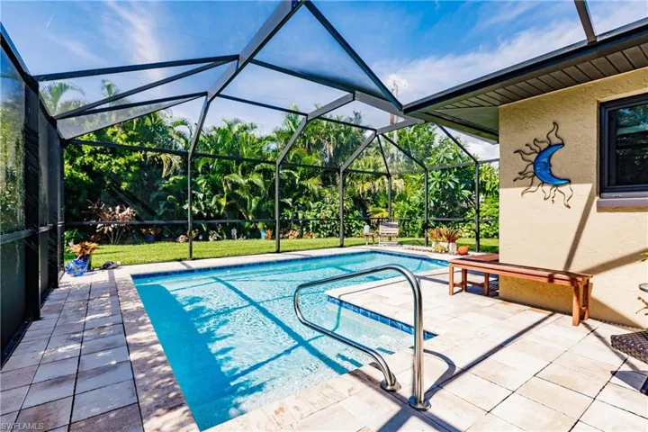 View of pool with a lanai and a patio area