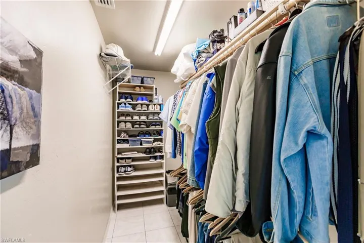 Walk in closet with light tile patterned flooring