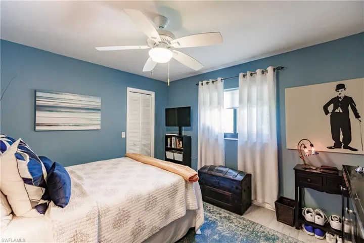 Bedroom featuring ceiling fan, light hardwood / wood-style flooring, and a closet