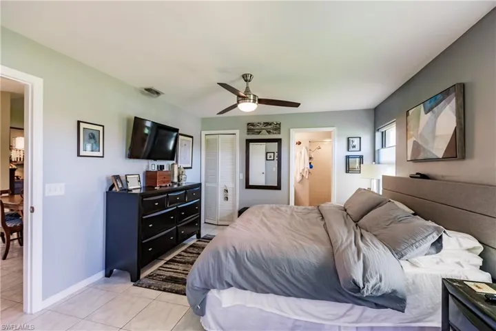 Bedroom featuring a closet, ceiling fan, and light tile patterned floors