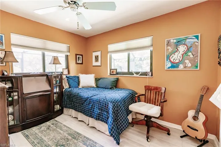 Bedroom with light hardwood / wood-style floors and ceiling fan
