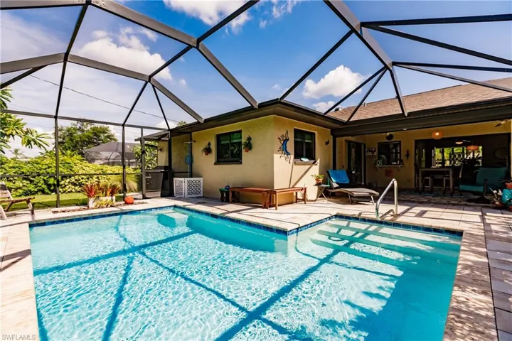 View of swimming pool featuring a patio area and a lanai
