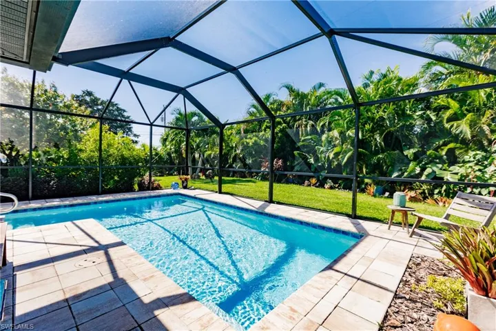 View of swimming pool with a lanai