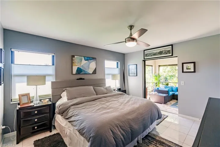 Tiled bedroom featuring ceiling fan
