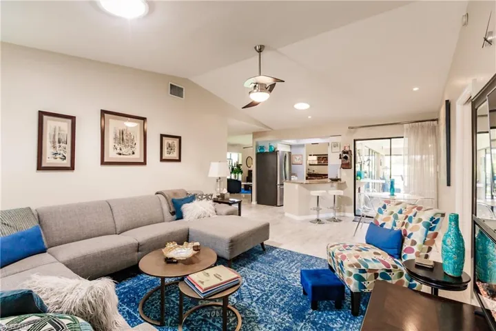 Living room featuring light hardwood / wood-style flooring and lofted ceiling