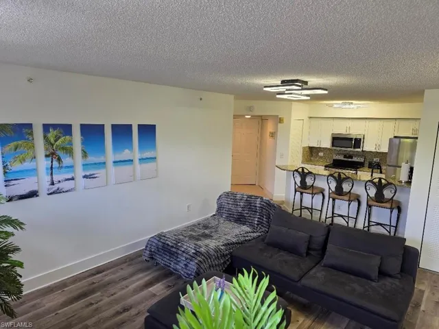 Living room featuring wood finished floors and a textured ceiling