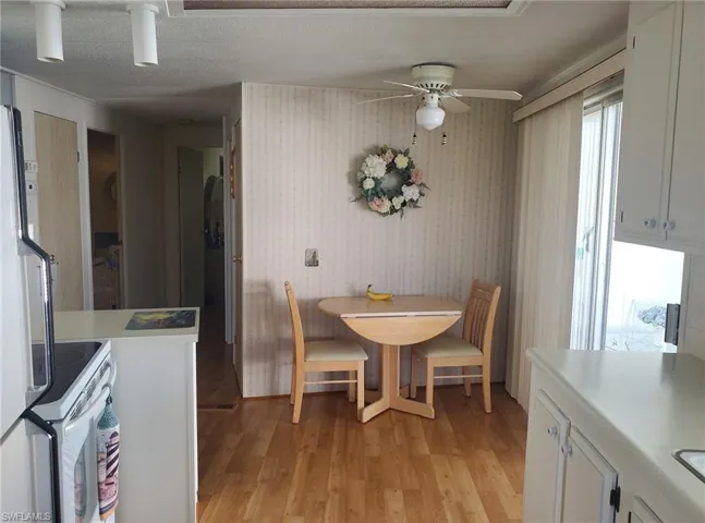 Eat-in kitchen features lustrous wood laminate floors.