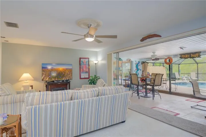 Living area with a sunroom and ceiling fan