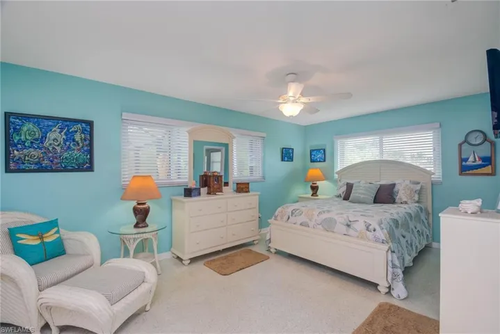 Bedroom with a ceiling fan and carpet flooring