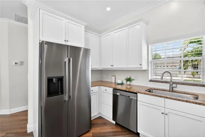 Updated kitchen featuring new Samsung appliances and a charming farmhouse sink.