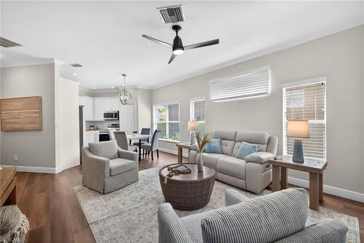 This elegant living room is filled with natural light thanks to its desirable south-facing and western exposure, creating a bright, warm, and inviting feel throughout the home.