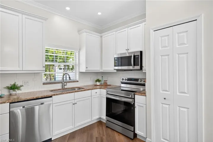 Updated kitchen featuring new Samsung appliances and a charming farmhouse sink.