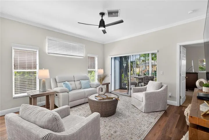This elegant living room is filled with natural light thanks to its desirable south-facing and western exposure, creating a bright, warm, and inviting feel throughout the home.