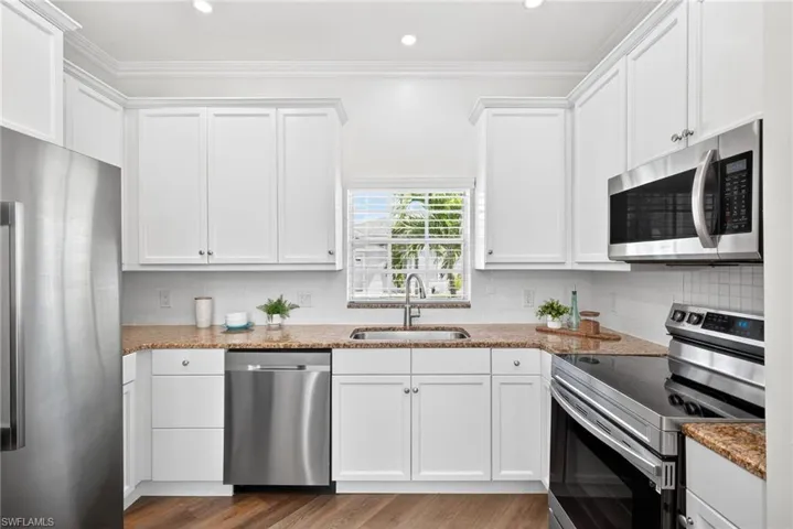 Updated kitchen featuring new Samsung appliances and a charming farmhouse sink.