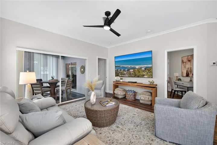 This elegant living room is filled with natural light thanks to its desirable south-facing and western exposure, creating a bright, warm, and inviting feel throughout the home.