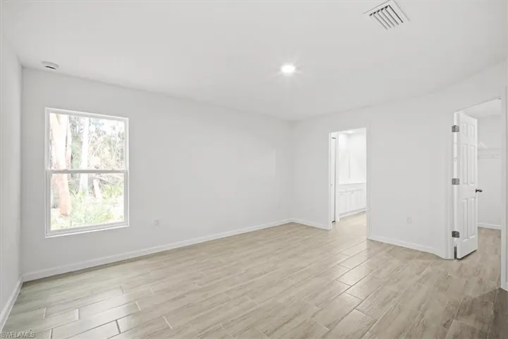 Spare room featuring wood tiled floors
