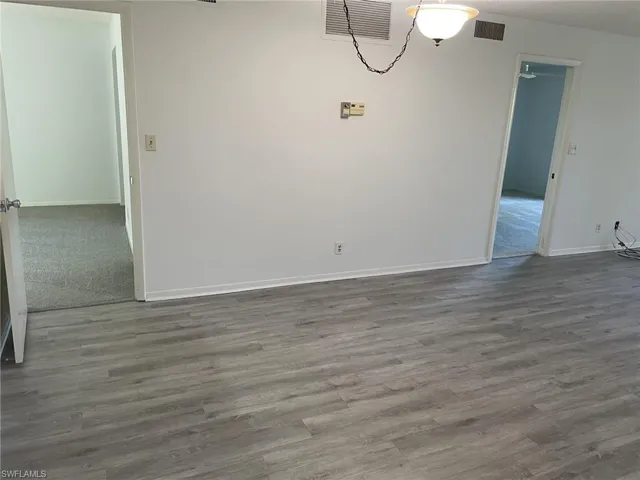 Unfurnished dining area featuring wood finished floors