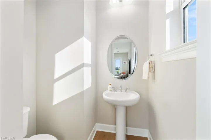 Bathroom featuring hardwood / wood-style flooring and toilet