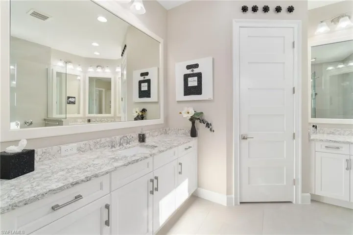 Bathroom with tile patterned floors and vanity
