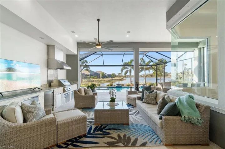 Living room featuring a water view and ceiling fan