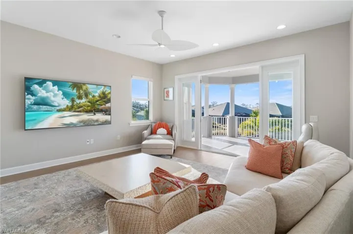 Living room with hardwood / wood-style floors and ceiling fan