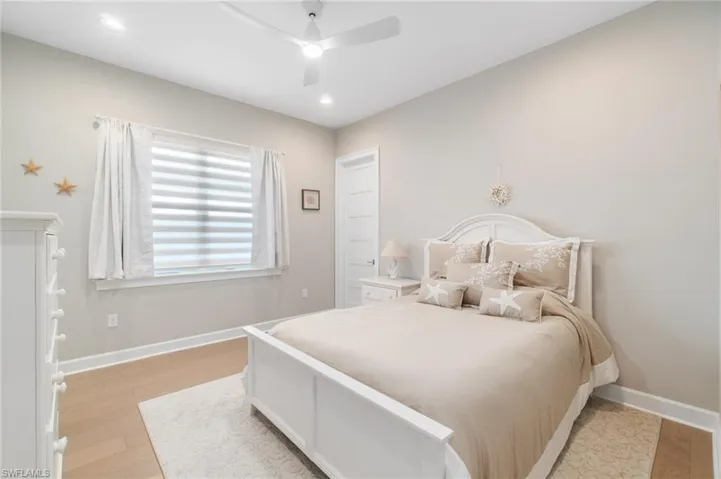 Bedroom featuring ceiling fan and light hardwood / wood-style floors