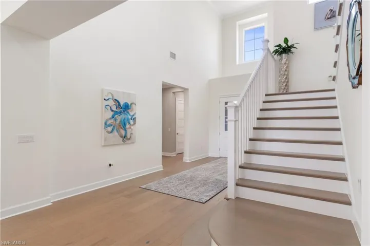 Entrance foyer featuring a high ceiling and hardwood / wood-style floors